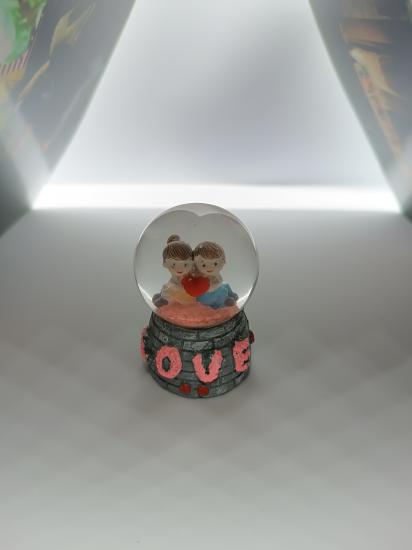 Lover themed illuminated snow globe.